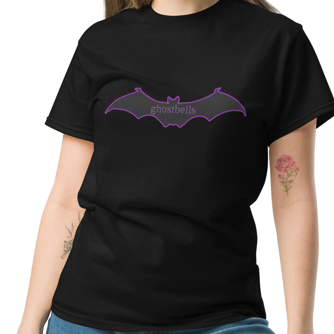 Woman wearing a black t-shirt with a purple bat logo on a white background
